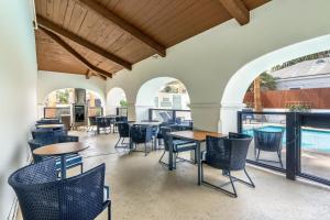 a dining room with tables and chairs and a large window at Mason Beach Inn in Santa Barbara