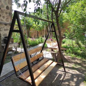 a swing in a yard with a tree at Narek B&B in Goris