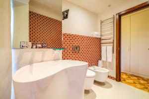 a bathroom with a white tub and a toilet at Sintra Boutique Hotel in Sintra