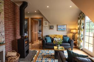 a living room with a wood stove at Tanar View in Aboyne