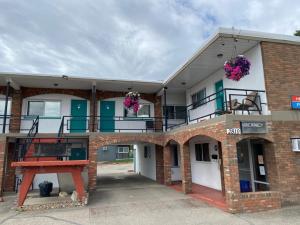 a large brick building with balconies on top of it at Schell Motel in Vernon