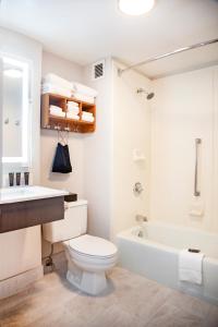 a bathroom with a toilet and a sink and a bath tub at Extended Stay America Suites Springfield in Springfield