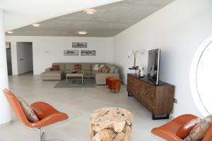a living room with a couch and a table at Villa Ozeano in Costa Calma