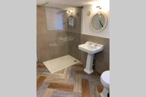 a bathroom with a sink and a toilet and a mirror at ROSE COTTAGE in Rowlands Castle +32 photos