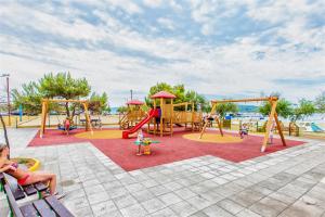 a playground with children playing in a park at Apartments gabrijel in Vodice