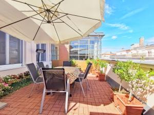 a patio with a table and chairs and an umbrella at Rumbach Terrace Apartment in Budapest