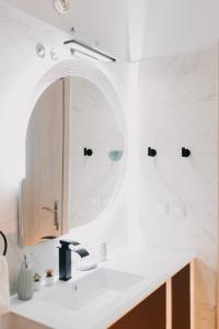 a bathroom with a sink and a mirror at the SummerHouse Project in Perítheia
