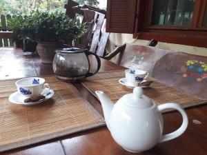 a table with a tea pot and cups on it at Family House in Buşteni