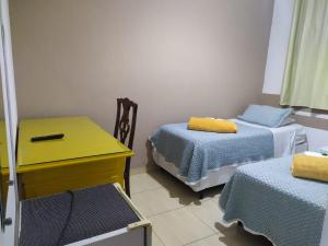 מיטה או מיטות בחדר ב-Hospedaria Ipiranga
