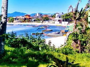 a group of boats on the shore of a beach at Moradas Cantinho da Guarda in Guarda do Embaú