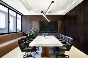 a conference room with a table and chairs and a tv at Crowne Plaza Sydney Burwood, an IHG Hotel in Sydney