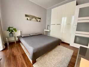 sypialnia z łóżkiem i białą szafką w obiekcie Apartament CHANELLKA Garnizon Gdańsk w Gdańsku