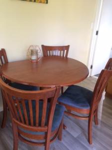 a wooden table with chairs and a wooden table with a glass at Tui Glen in Raurimu Spiral