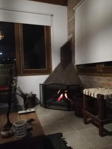 a fireplace in a living room with a fire at ROSALIMON in Nueva Palmira