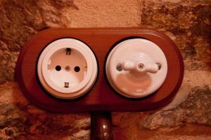 a switch on a wall with a face on it at Calzada Romana in Cedeira