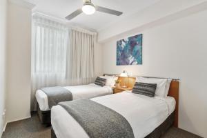 a bedroom with a large bed and a large window at Republic Apartments Brisbane City in Brisbane