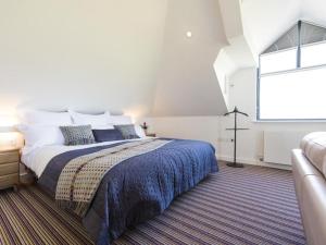 a bedroom with a large bed and a window at chyreen@marazion in Marazion