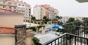 a view from the balcony of a building with a swimming pool at Apartamento com varanda no IL Campanário Resort in Florianópolis