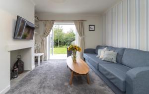 a living room with a blue couch and a table at Number Five in Somerton