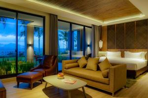 a living room filled with furniture and a window at Ketapang Indah Hotel in Banyuwangi