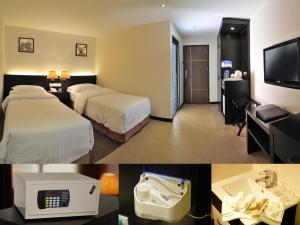 a hotel room with two beds and a bathroom at ERNES Hotel in Perai