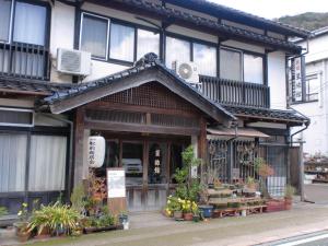a building with a flower shop on the street at Hoshi Ryokan in Tsuwano