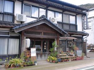 a building with a flower shop on the street at Hoshi Ryokan in Tsuwano