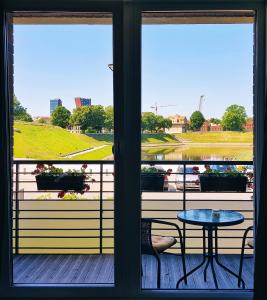 a view from a window of a patio with a table and chairs at No.1 Apartment Link-To-Happiness in Klaipėda