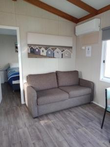 a living room with a couch and a bedroom at Lang Lang Caravan Park 