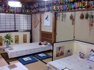 a room with two tables and mats on the floor at Hoshi Ryokan in Tsuwano