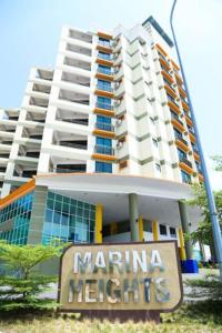 a large building with a sign in front of it at Marina Heights Seaview Resort Apartment II in Lumut