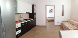 a kitchen with black cabinets and a couch in a room at the Mainstreet in Agerola