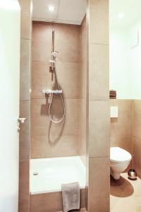 a bathroom with a shower and a toilet at Apartment "Paris" in Korschenbroich