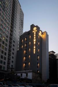 a tall building with lights on the side of it at Seomyeon Brown-dot hotel Gold in Busan