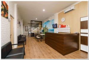 a restaurant with a counter and a dining room at RedDoorz near JIEXPO Kemayoran 2 in Jakarta