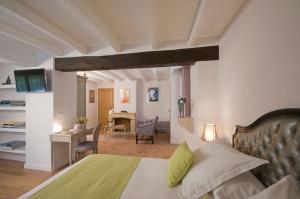 a bedroom with a bed and a desk at Le Mas du Chanoine in Saint Paul de Vence +26 photos