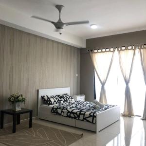 Un dormitorio con una cama y un ventilador de techo. en Shah City @ i-SoHo, en Shah Alam
