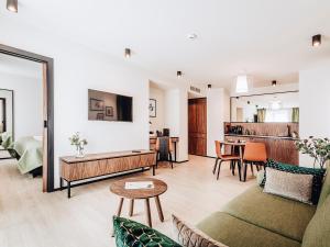 a living room with a couch and a table at Apartamenty Sowa Bydgoszcz in Bydgoszcz