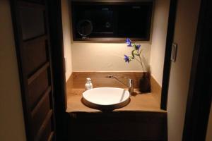 a bathroom with a toilet and a sink and a window at Onoan in Hida