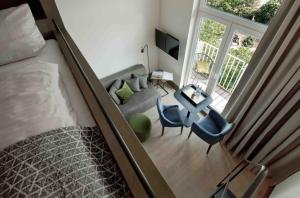 a room with a bed, chair and a window at OBERDECK Studio Apartments - Adults only in Hamburg