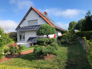 uma casa com painéis solares no telhado em Ferienwohnung Kuhn em Rhumspringe