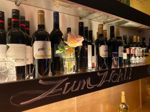 a bunch of bottles of wine on a shelf at HOTEL ZILLNERs EINKEHR *** in Altheim