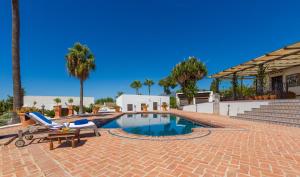 a swimming pool with a chaise lounge and a table at Cortijo Boutique Marbella in Marbella