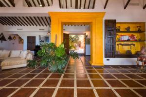 a living room with yellow columns and a couch at Cortijo Boutique Marbella in Marbella