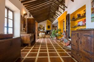 a living room with a large ceiling and a tiled floor at Cortijo Boutique Marbella in Marbella