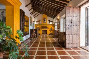 a large room with yellow walls and a tile floor at Cortijo Boutique Marbella in Marbella