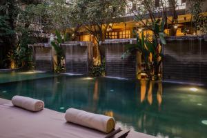 a swimming pool with two white objects in the water at Jaya House River Park in Siem Reap