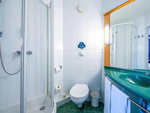 a bathroom with a sink and a toilet and a shower at Ibis Katowice - Zabrze in Zabrze