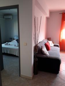 a room with a bed and a vase with pillows at Appartement Tavira in Tavira