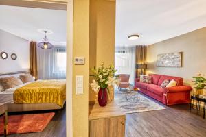 a hotel room with a bed and a couch at Club Luxury Apartman in Sárvár +39 photos